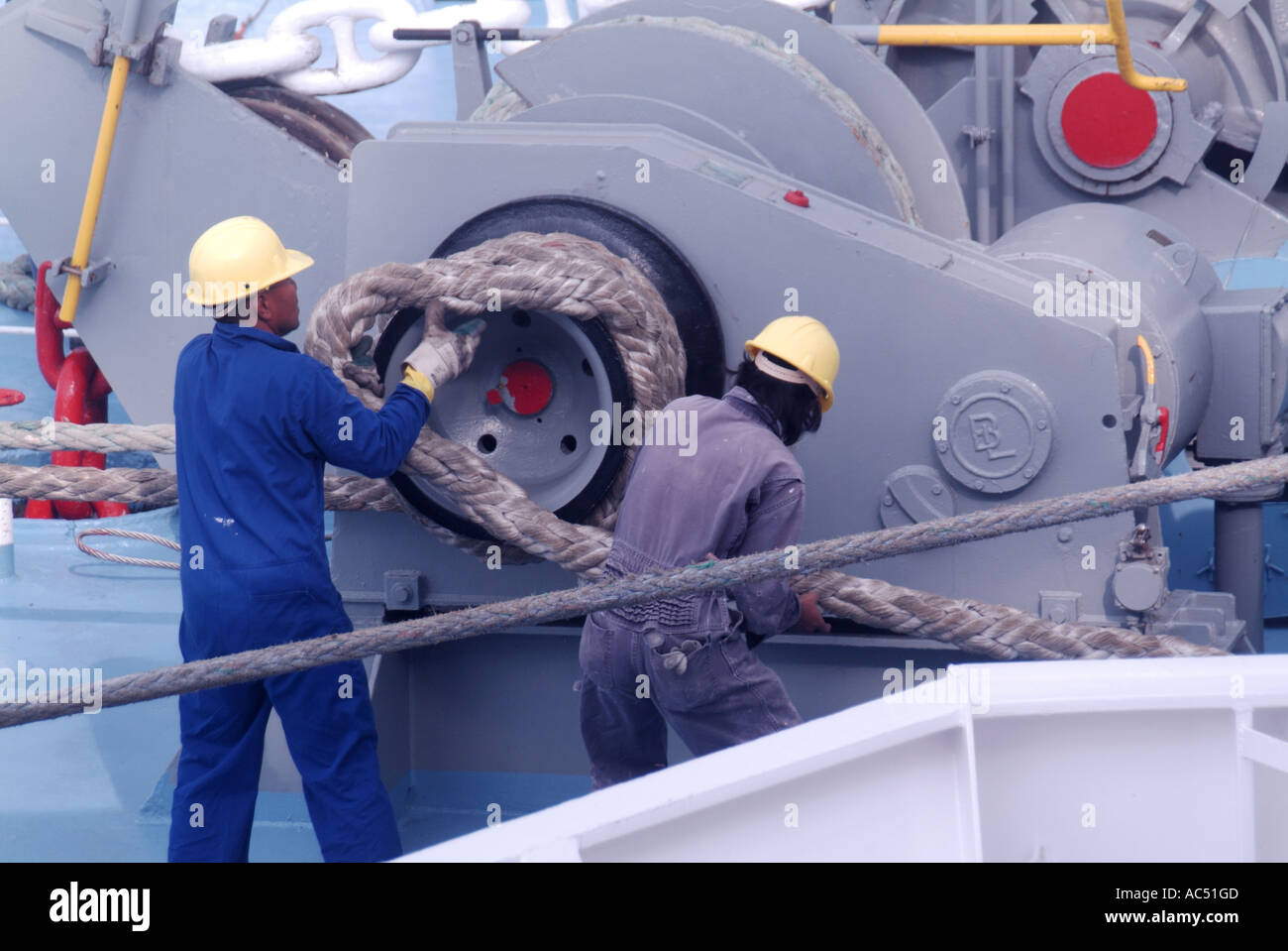 Ajaccio port cruise ship crew guiding heavy duty mooring rope during