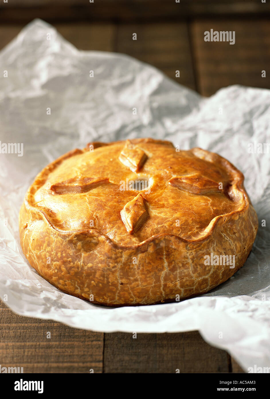 Pork Pie country English British classic traditional farm shop butcher golden pastry whole Stock Photo