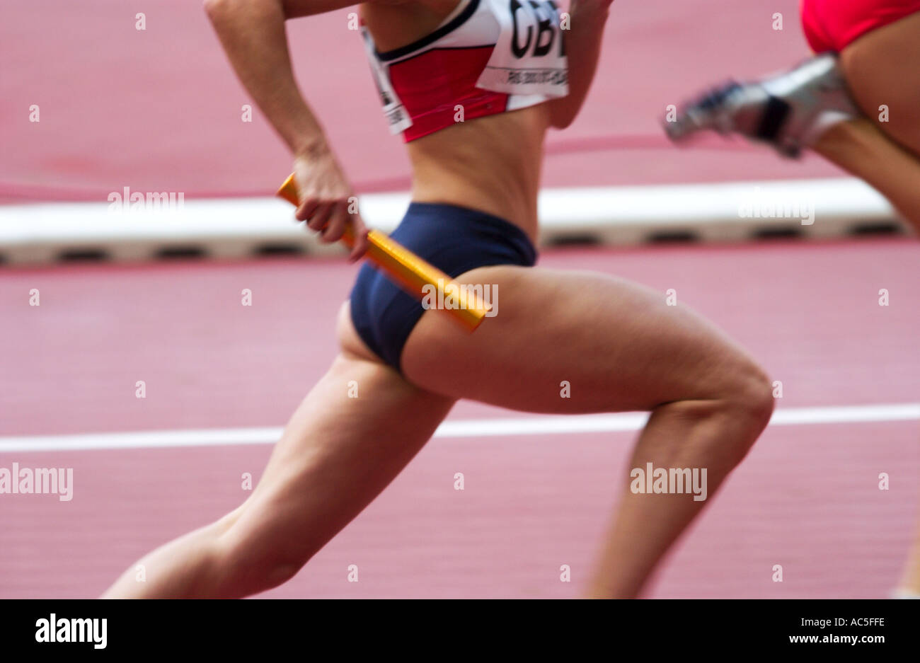 female competitor in a relay race Stock Photo Alamy