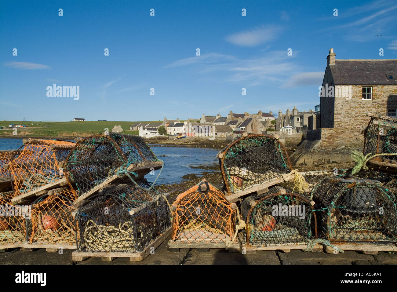 dh St Margarets Hope waterfront SOUTH RONALDSAY ORKNEY ISLES Lobster creels harbour houses town creel fishing scotland village quayside island uk Stock Photo