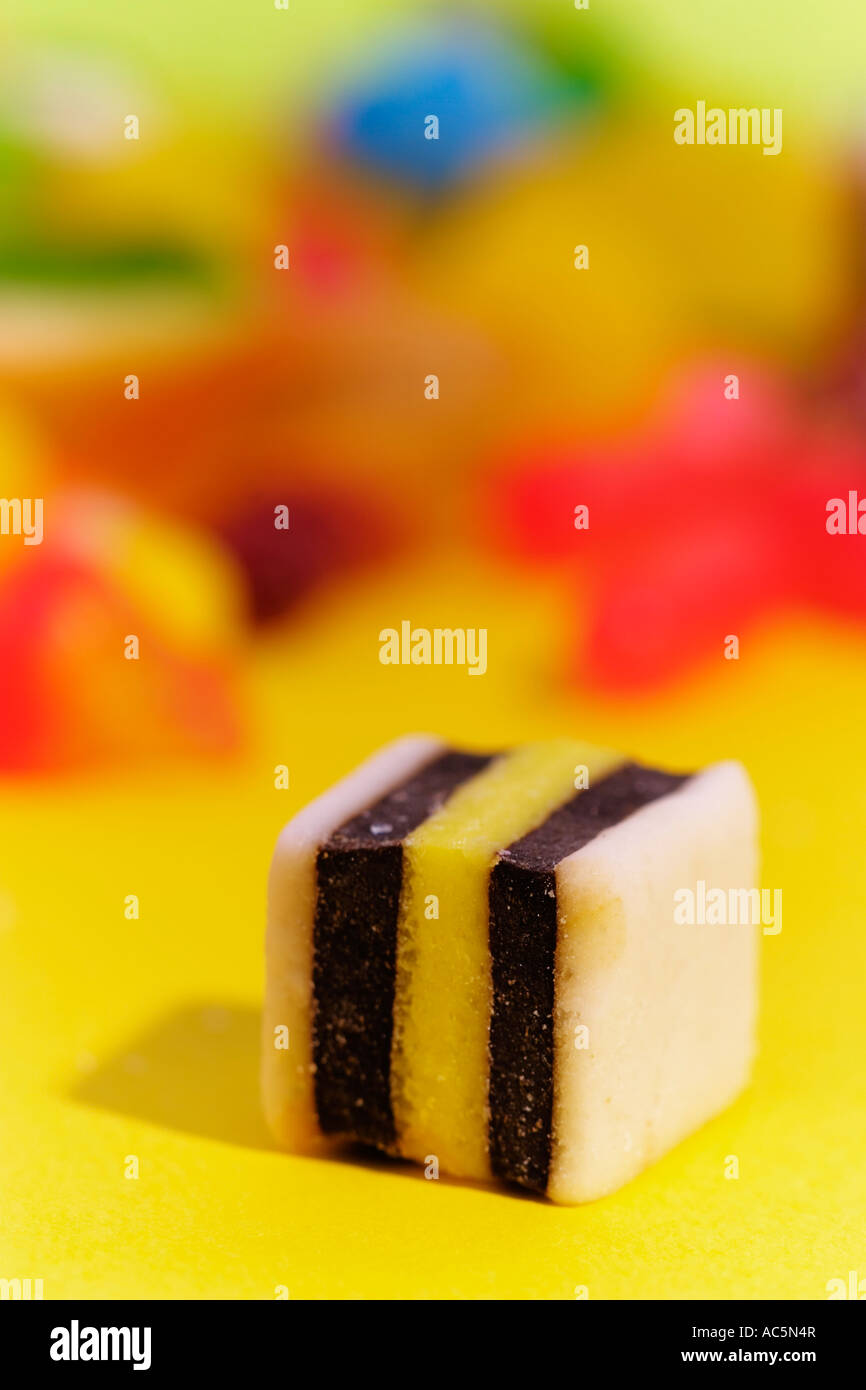 all sorts licorice candy with a pile of assorted candies in the background Stock Photo