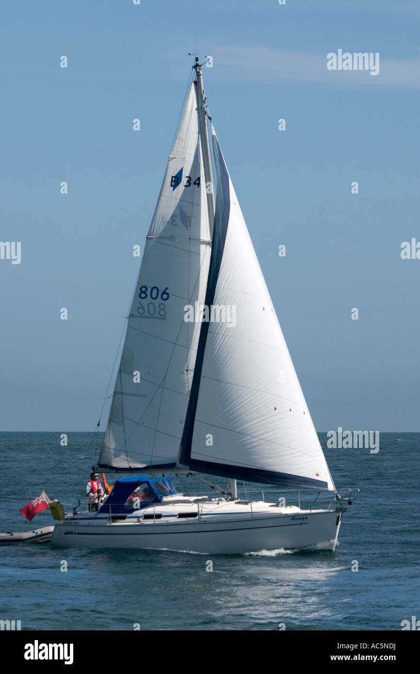 Pleasure yacht entering Poole Harbour in Dorset under full sail Stock Photo