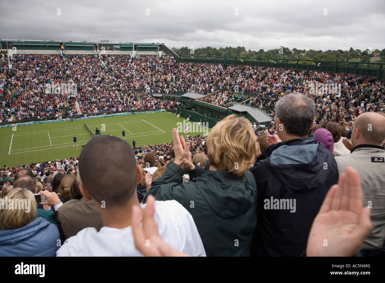 Spectators clapping Federer victory in opening game at Centre Court Wimbledon tennis Championship UK Stock Photo