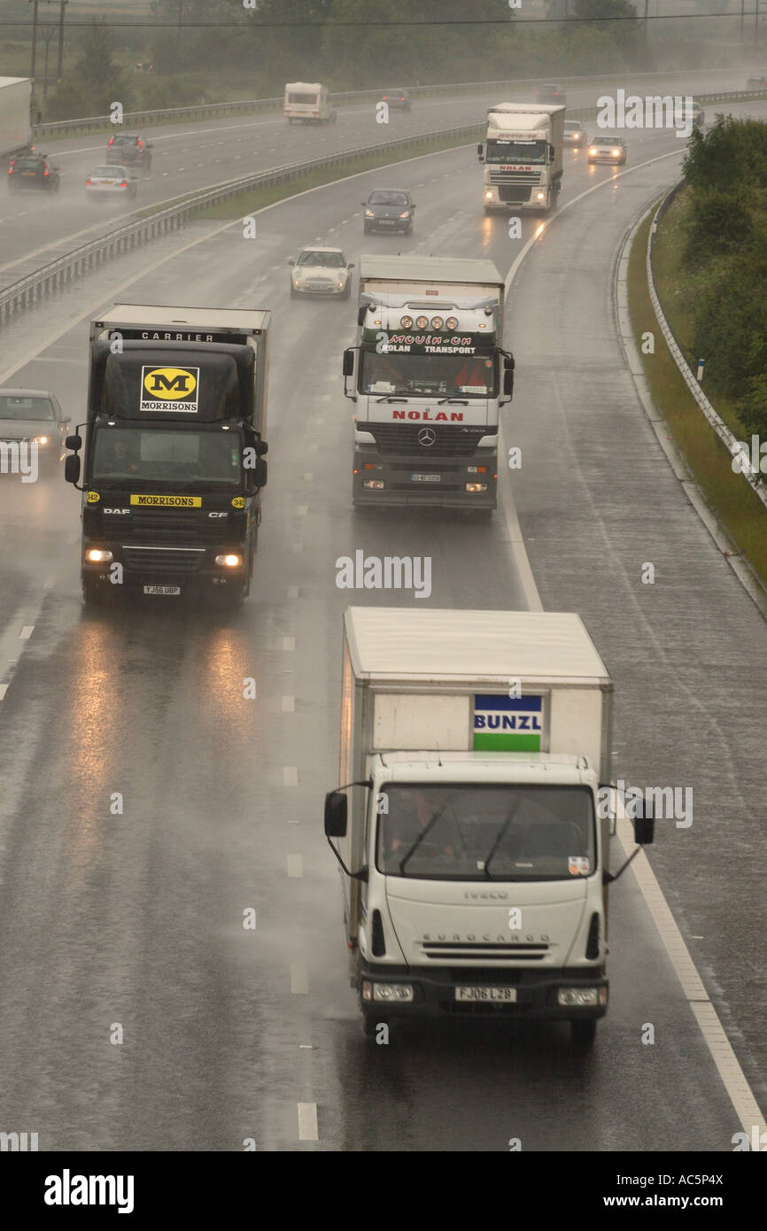 Cars and lorries driving in rain wet road conditions on M5 Motorway