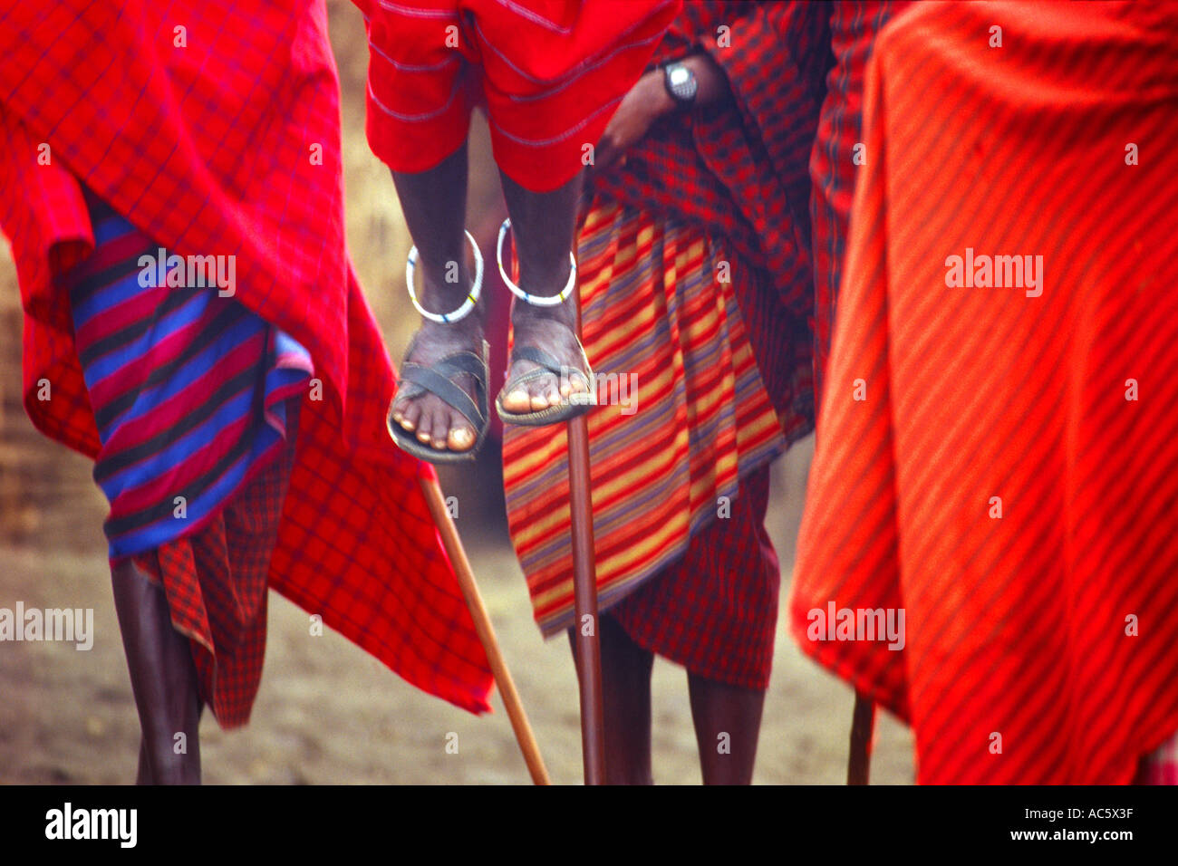 Masai tribesman performing ritual dance Serengetti Tanzania Masai tribesman Tanzania Red Robe Garb Tradition African Culture Stock Photo