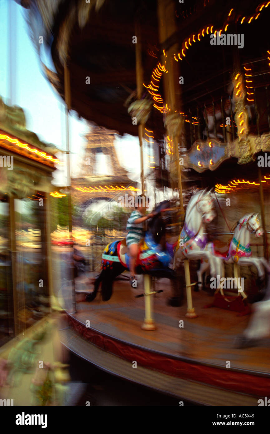 Young boy on Carousel near the Trocadero with the Eifel Tower in the