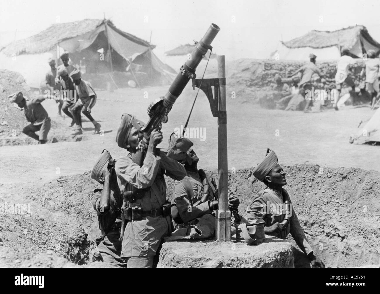 WWI Indian troops use a pole mounted Lewis gun against German aircraft in Palenstine in 1918 as others dive for cover Stock Photo