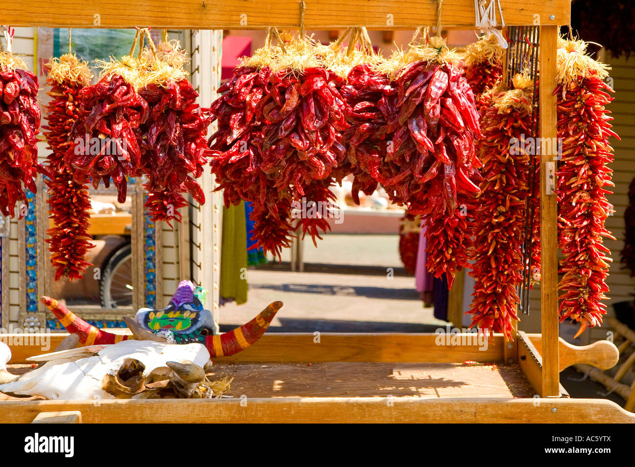 RED CHILE PEPPERS HANGING ON STORE FRONT CHIMAYO, NEW MEXICO Stock