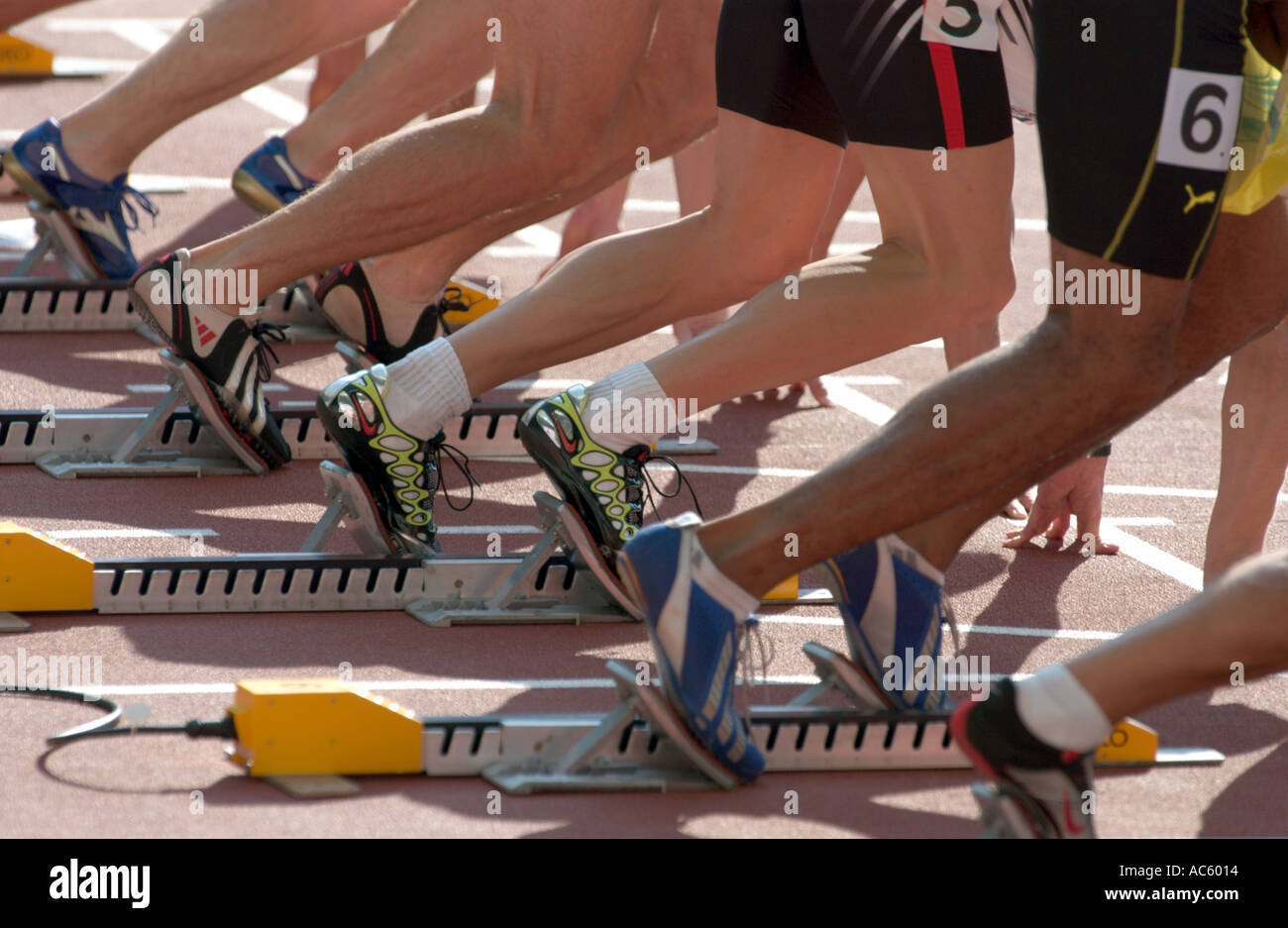 sprinters getting out of the starting blocks at the start of a race