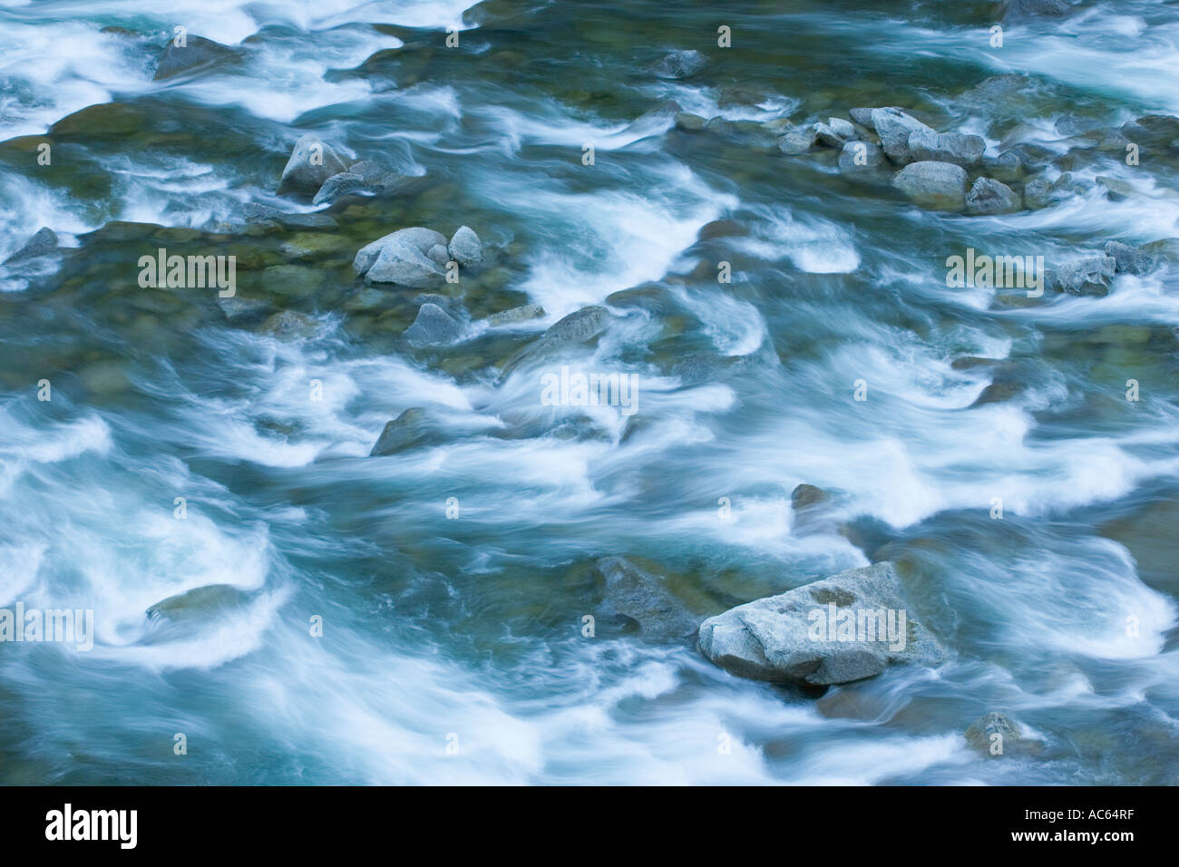 Detail of flowing river water over rocks Stock Photo - Alamy