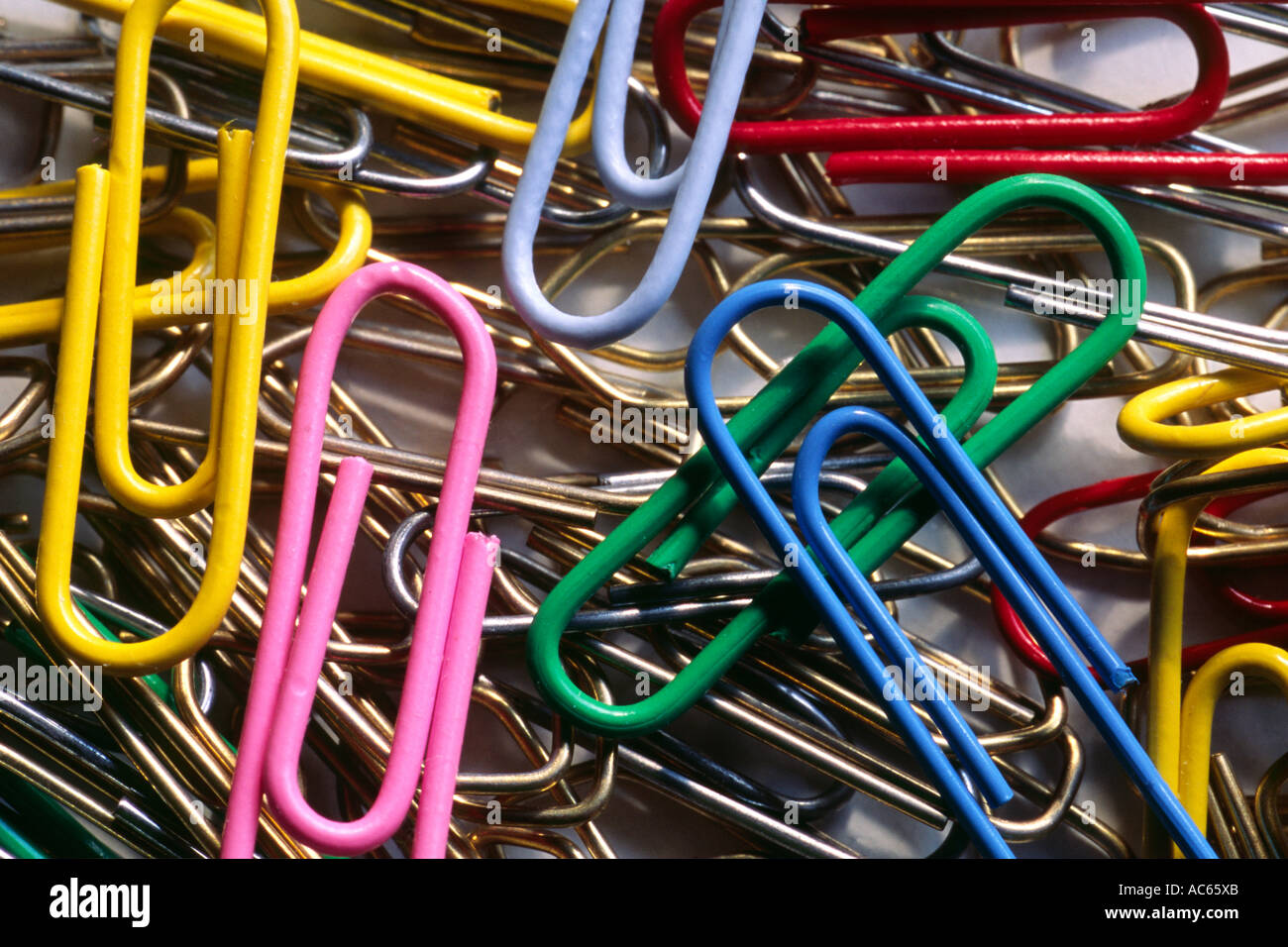 Coloured paper clips against white background Stock Photo