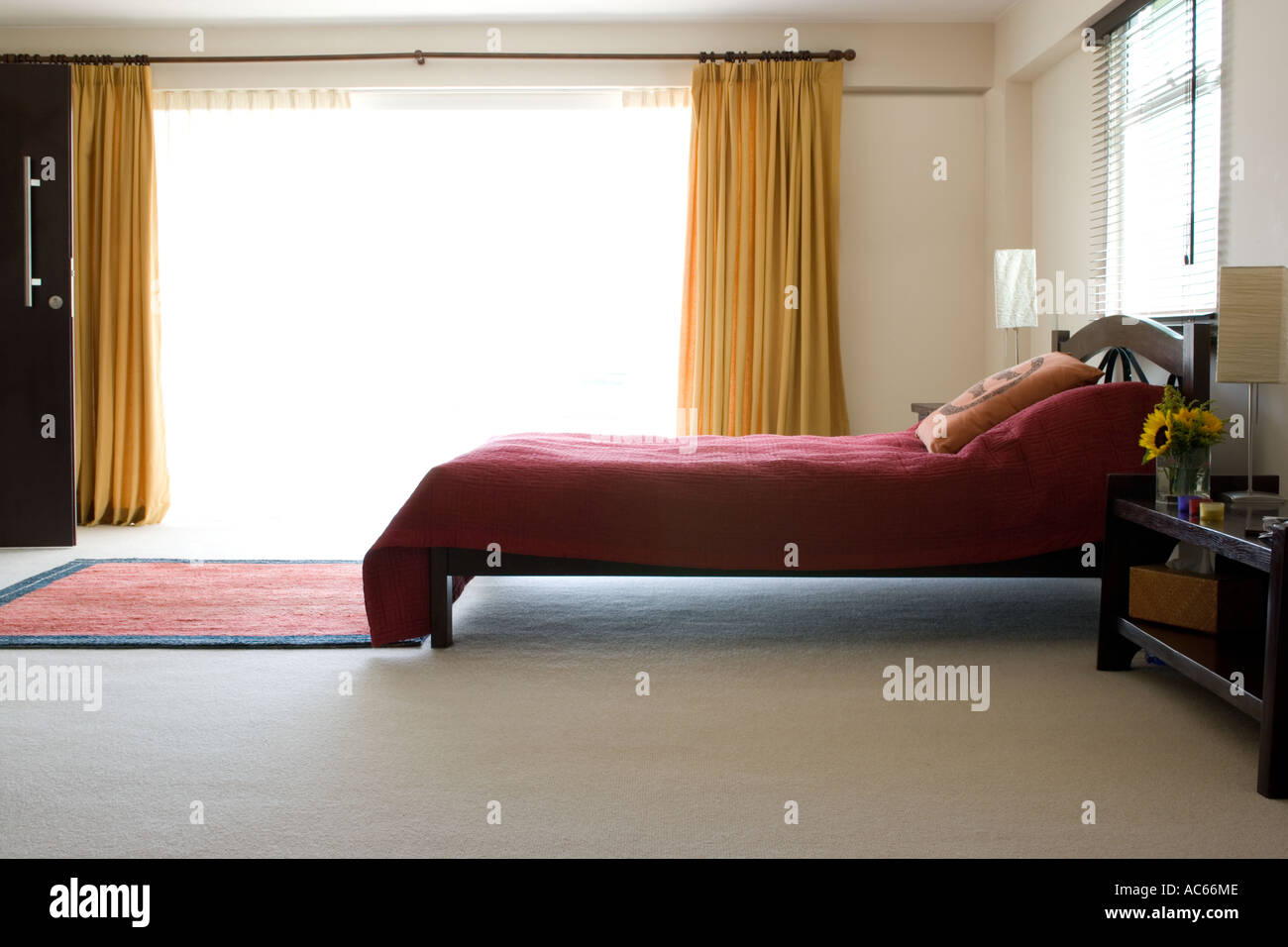 red bed with large open window Stock Photo - Alamy
