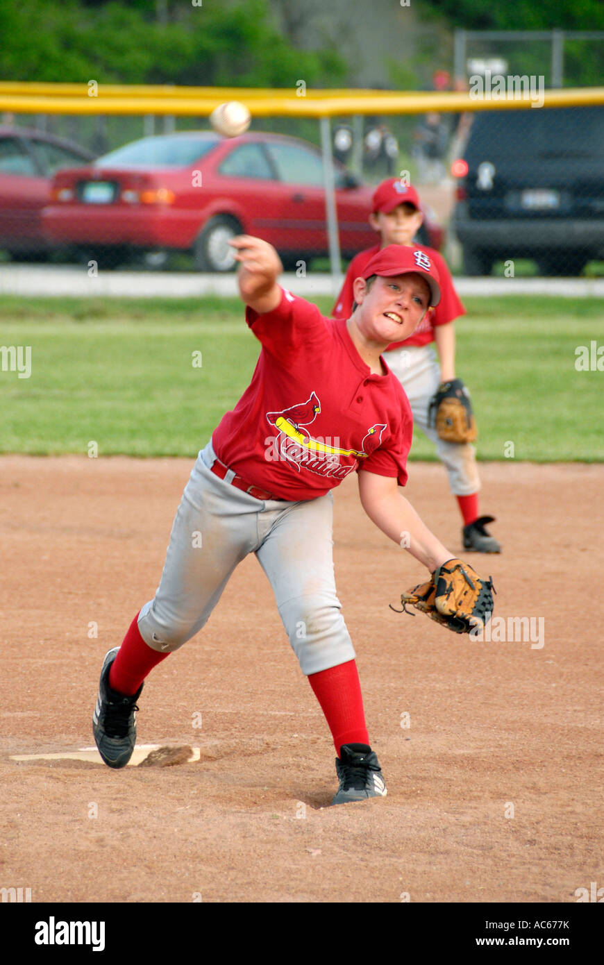 Little League baseball pitcher player throwing a baseball Stock Photo