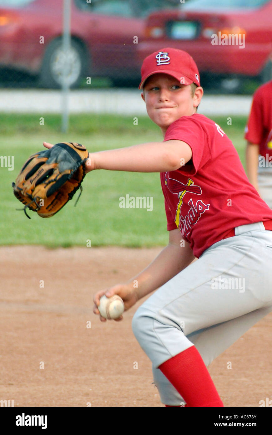 Little League baseball pitcher player throwing a baseball Stock Photo
