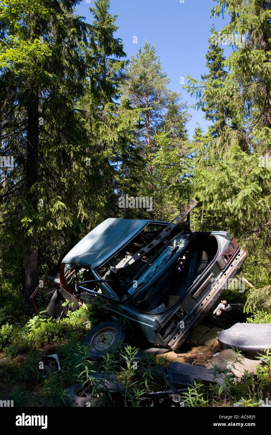 Car wreck in the forest , Finland Stock Photo