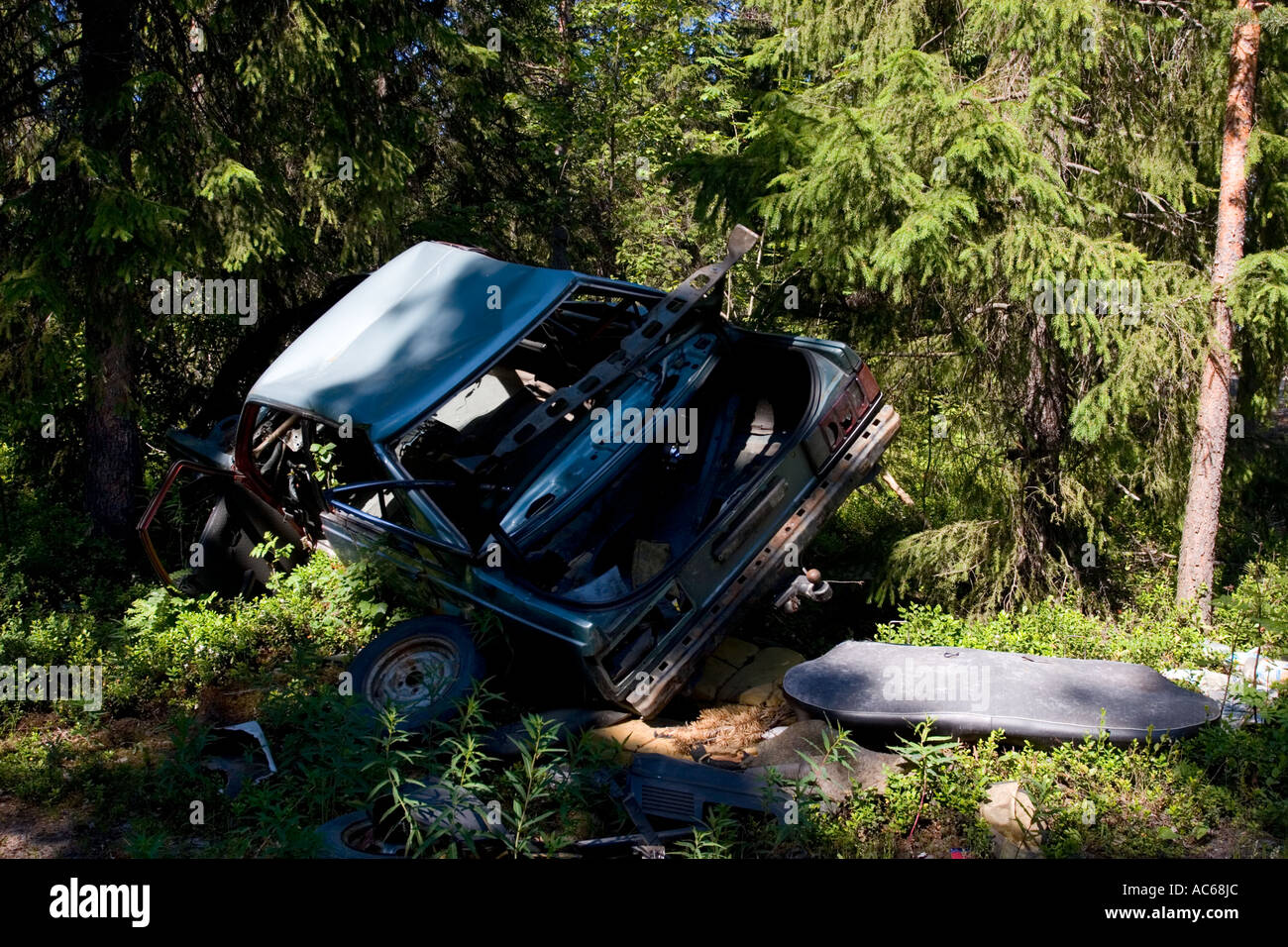 Car wreck in the forest , Finland Stock Photo