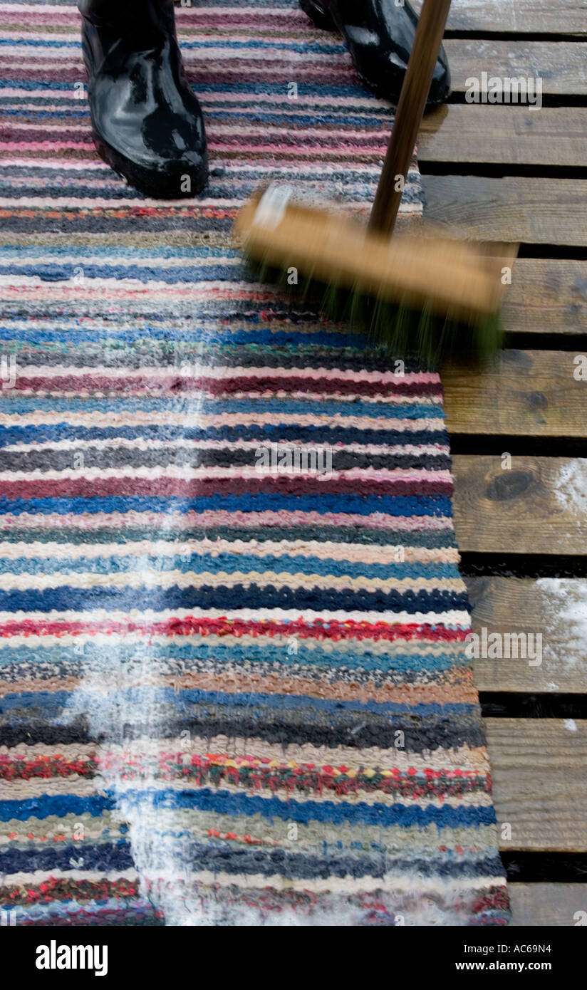 Scrubbing rag rug clean using tall oil soap and brush , Finland Stock