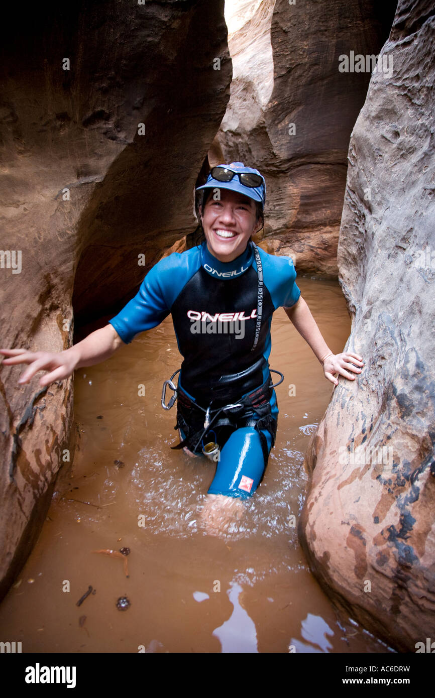Peggy Boggs wading through pool while canyoneering in Cheesebox Canyon