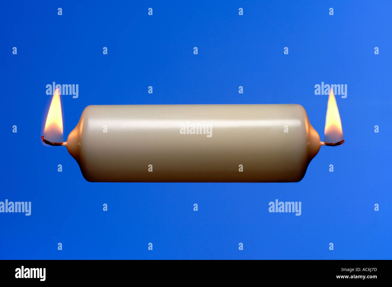 A candle burning at both ends Stock Photo Alamy