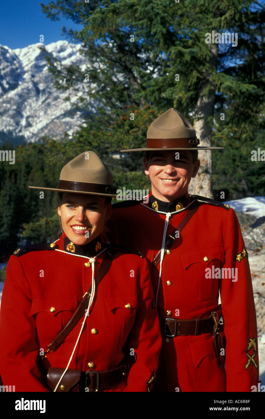 adult man and woman male and female Royal Canadian Mounted Police RCMP aka Canadian Mounties on duty in Canadian Rockies in Banff in Alberta Canada Stock Photo