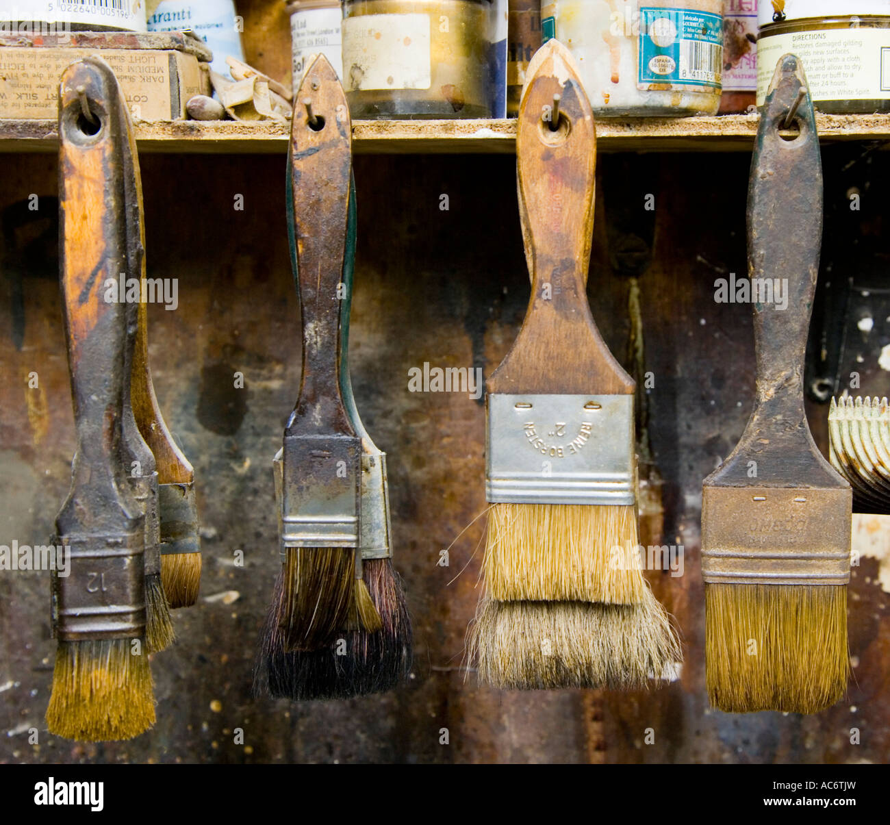 Paint brushes hanging up in a workshop Stock Photo