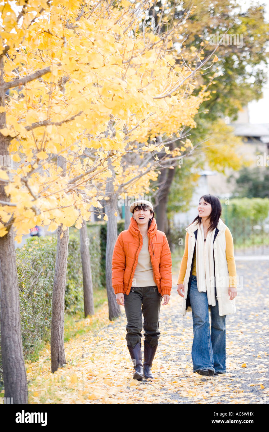 Two young women walking Stock Photo - Alamy