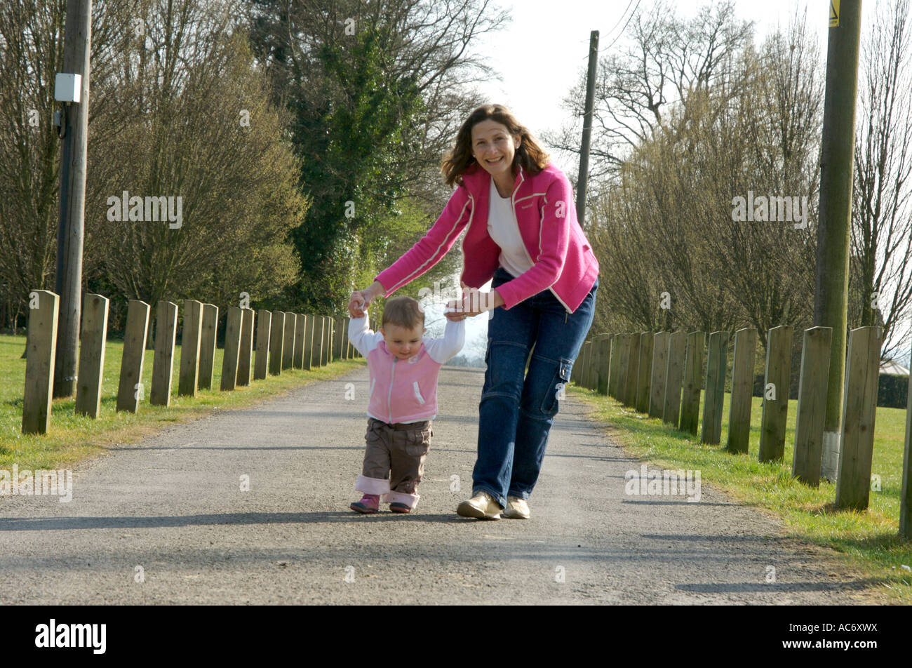mother and child walking for the first time Stock Photo
