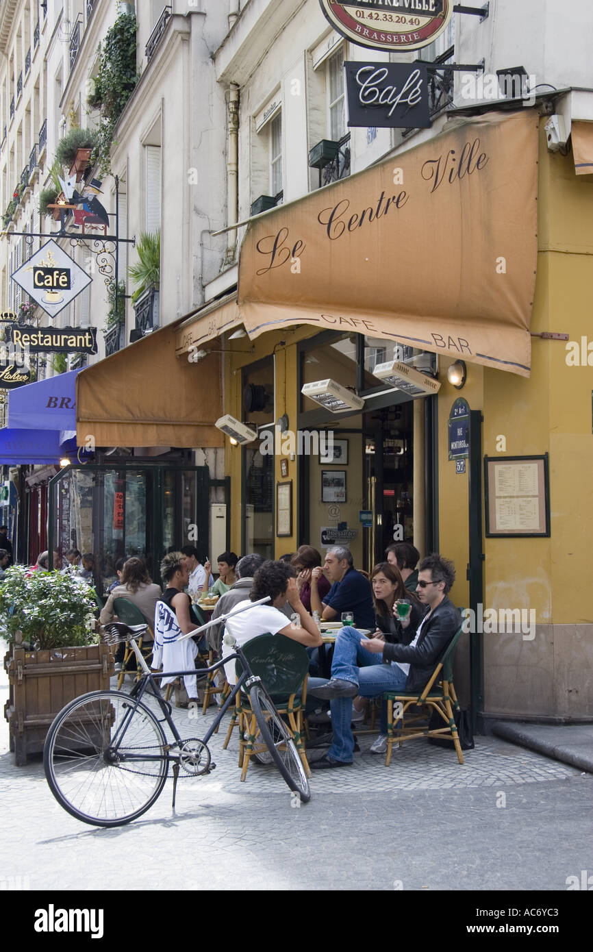 People sit a outdoor tables at Le Centre Ville Cafe on Rue Montorgueil ...