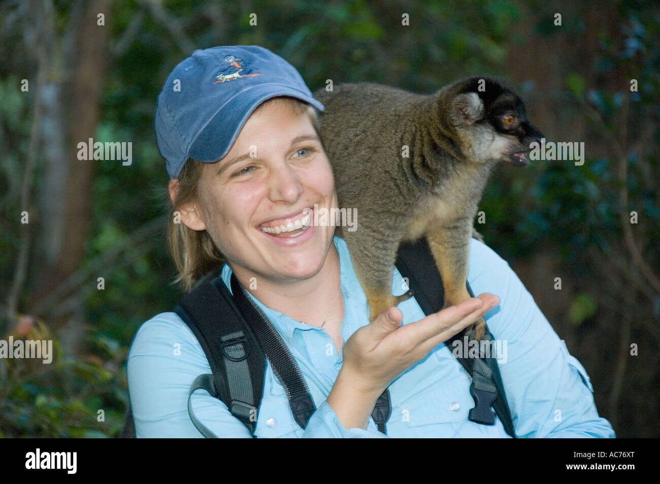 Tourist Meg Macy with captive Brown lemurs, Vakona Lodge, near Perinet Reserve, Madagascar Stock Photo