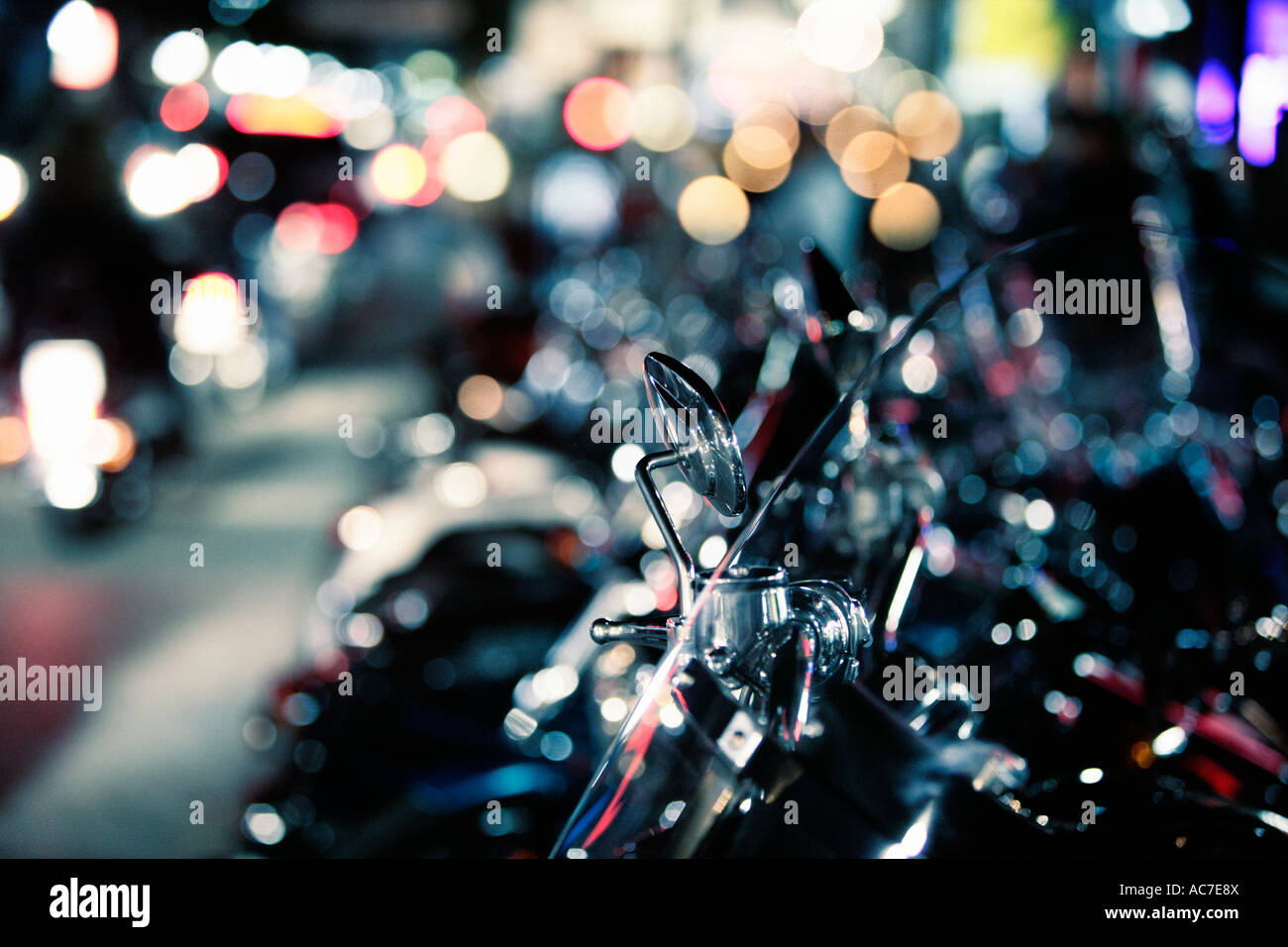 Row of Harley Davidson motorcycles parked up at night Stock Photo