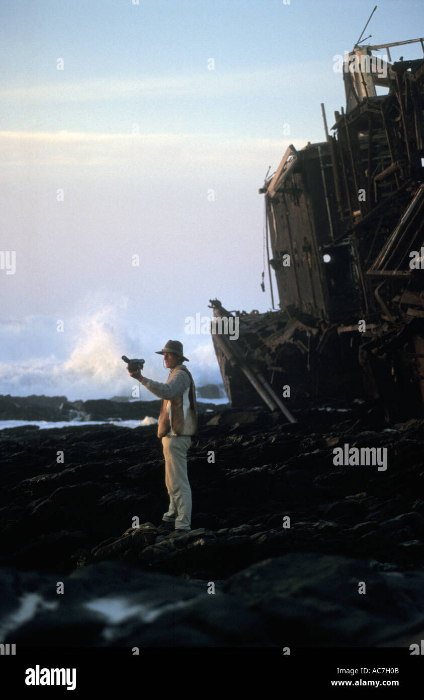 Explorer Benedict Allen filming himself next to a ship wreck on the Namib Naukluft desert coast Stock Photo