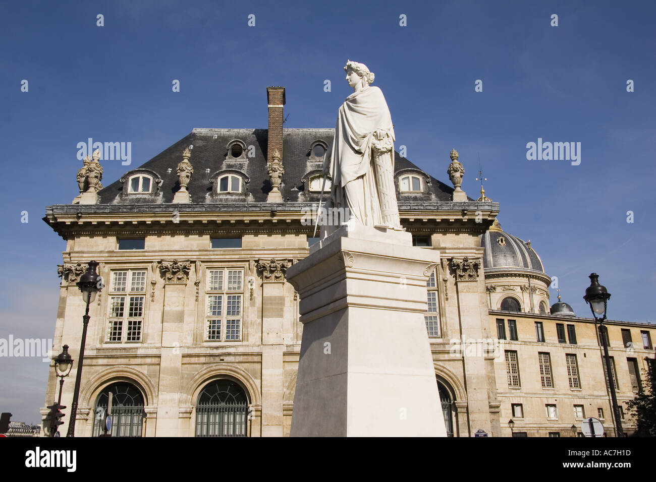 Statue of Jean Francios Soitoux on the Quai Malaquais with the Institut de France in back Paris France Stock Photo