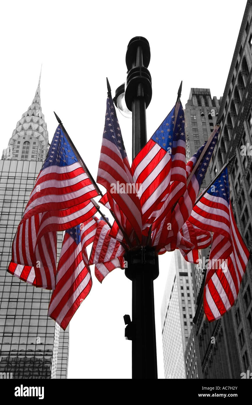 Stars and stripes american flags on lamppost lamp post with Empire State Building midtown Manhattan New York City NY NYC USA Stock Photo