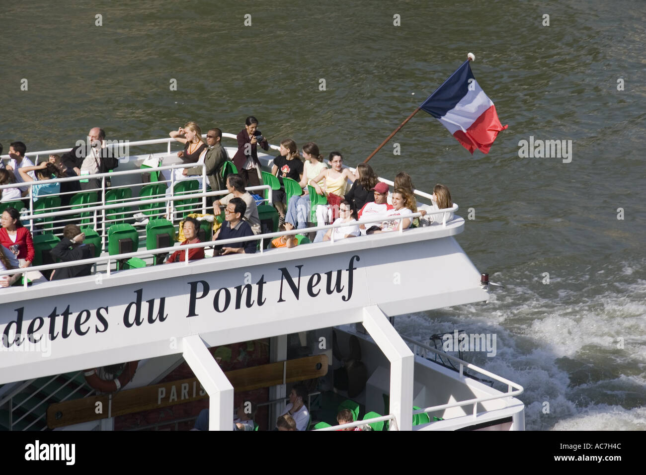 French Tri Color flag on stern of Vedettes du Pont Neuf river tour boat on the River Seine Paris