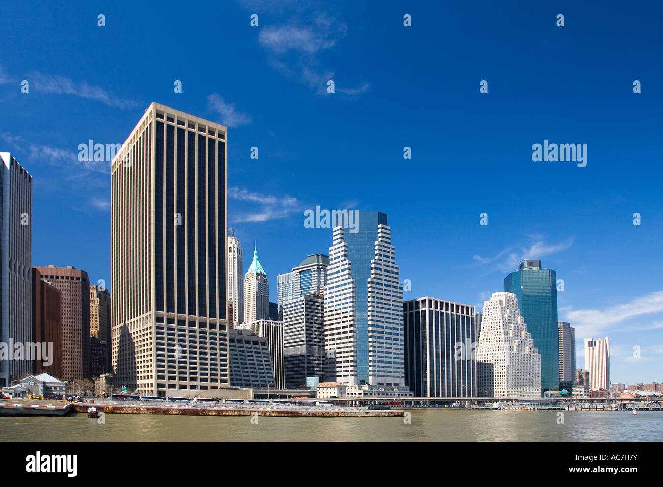 Lower Manhattan skyscrapers downtown skyline 'New York City' in sun sunshine with blue sky New York City NYC NY United States Stock Photo