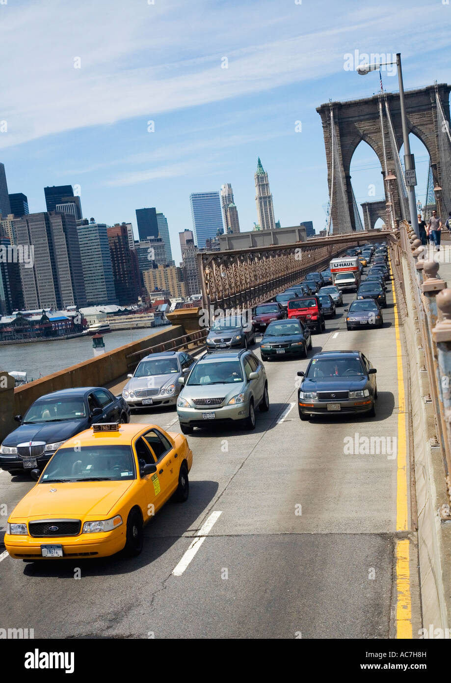 Yellow taxi cab and other traffic on the Brooklyn Bridge looking to Lower Manhattan downtown New York City NYC NY Stock Photo
