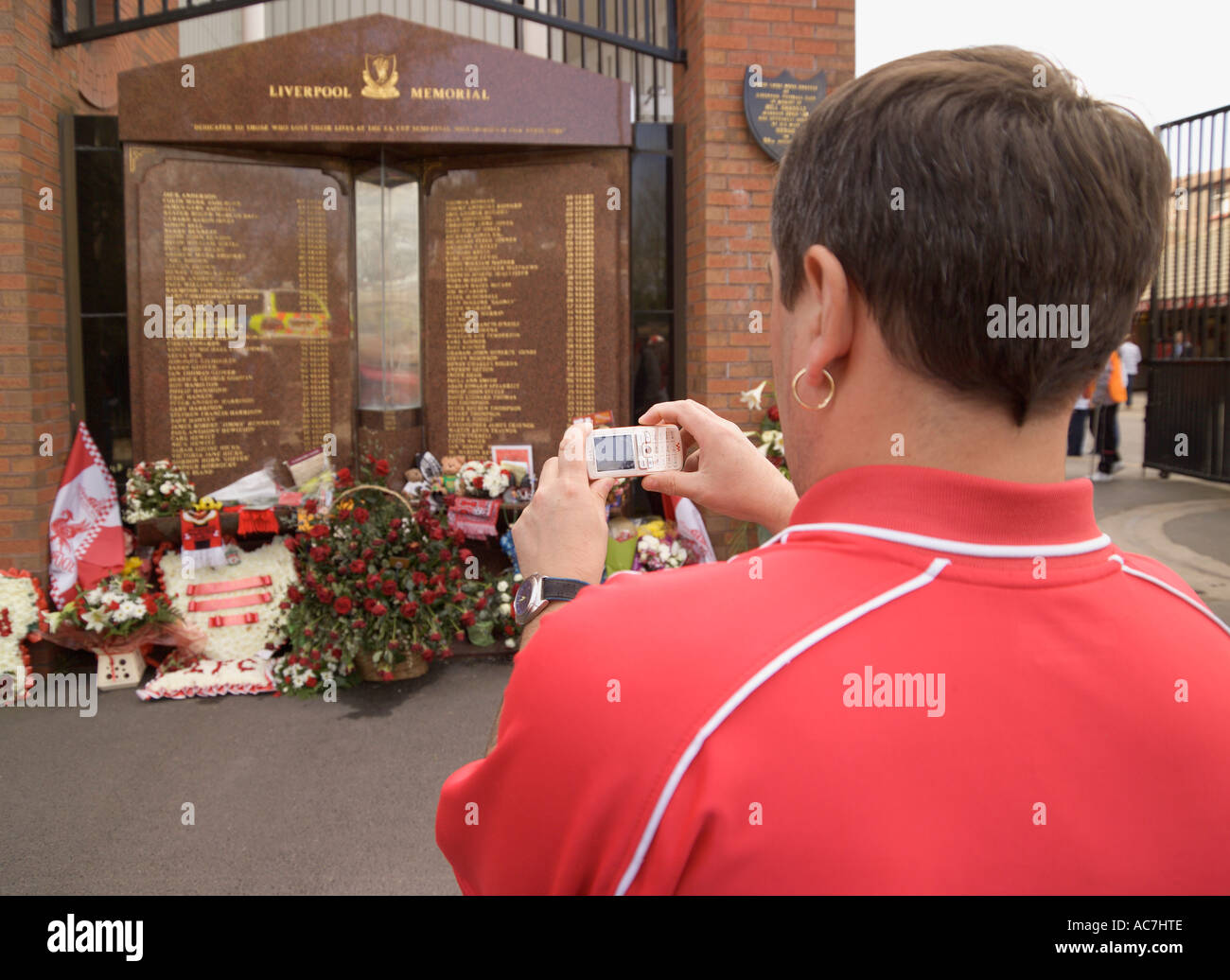 Fan taking a picture of Liverpool Memorial to fans who died at