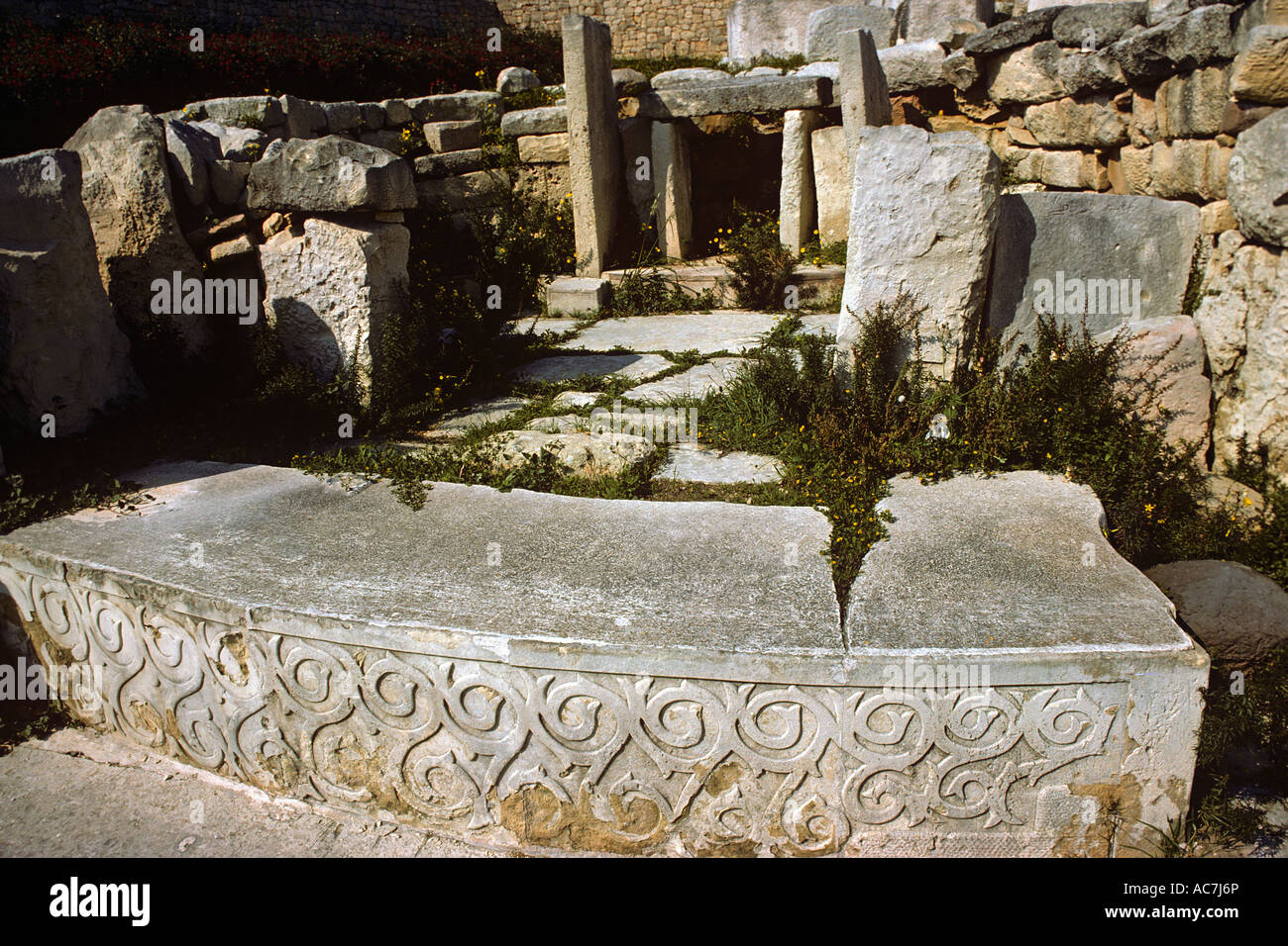 carved and decorated stone slab in front of altar within the Tarxien Temple on the Mediterranean Island of Malta Stock Photo