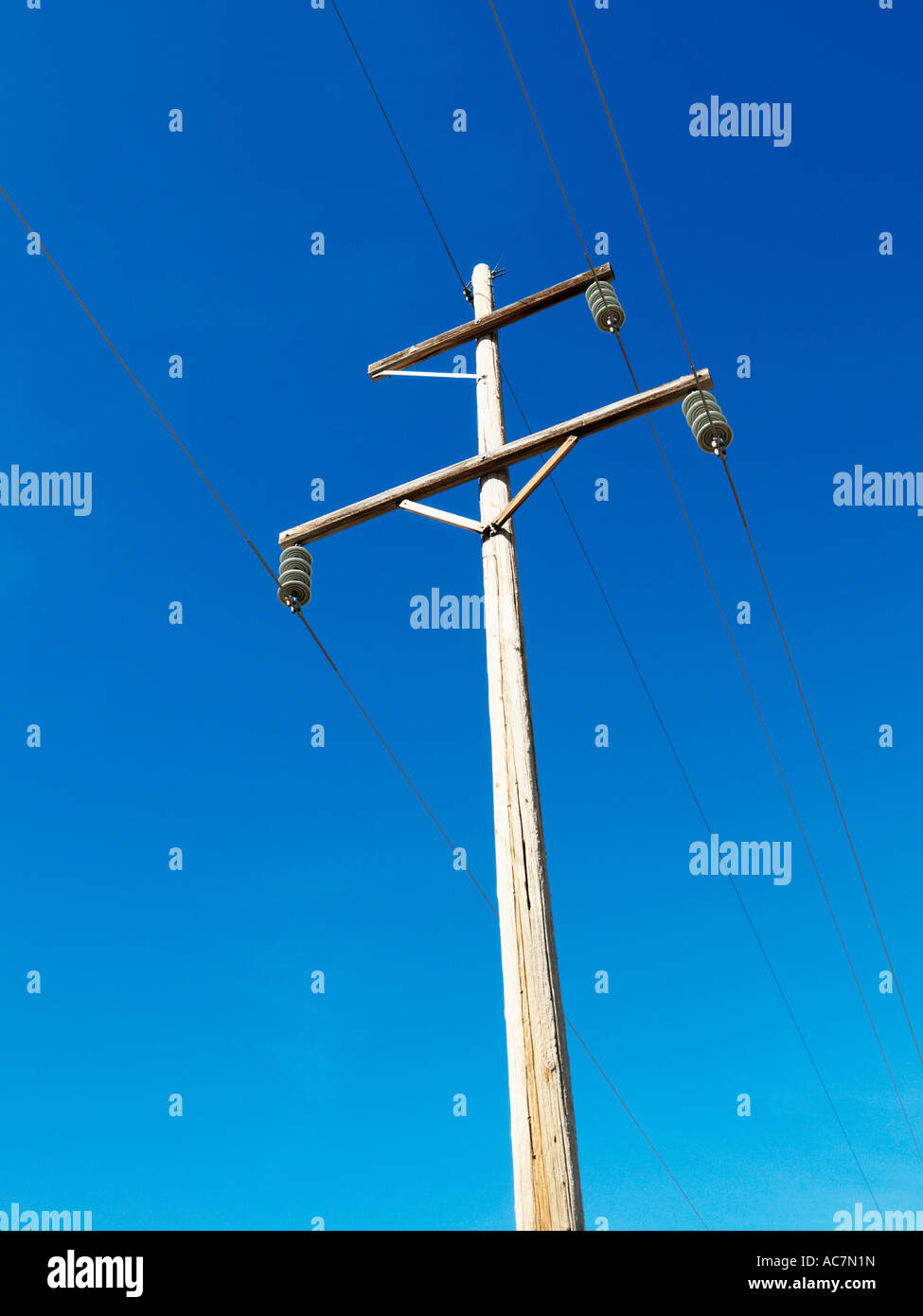 Power line against blue sky Stock Photo - Alamy
