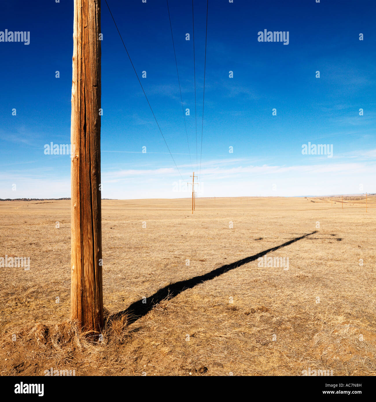 Power line against blue sky Stock Photo - Alamy