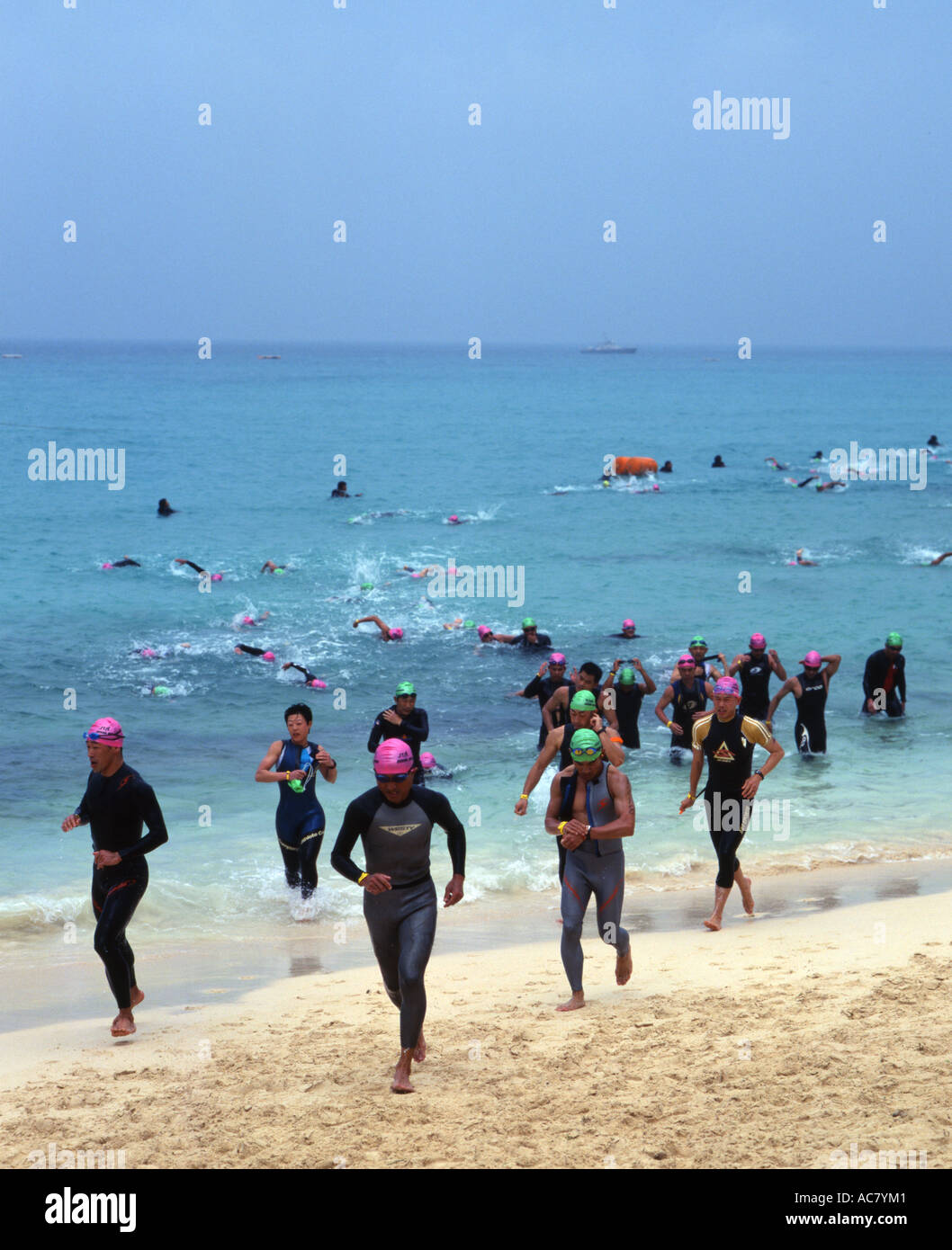 Swimmers run out of the ocean at the Miyako International Triathlon 2006 Stock Photo
