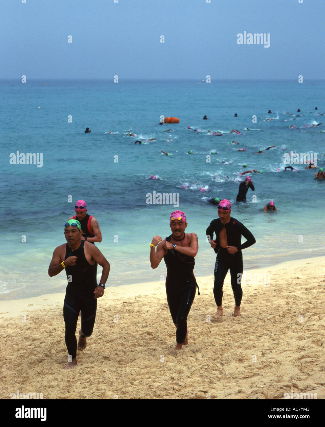 Swimmers run out of  the ocean at the Miyako International Triathlon 2006 Stock Photo
