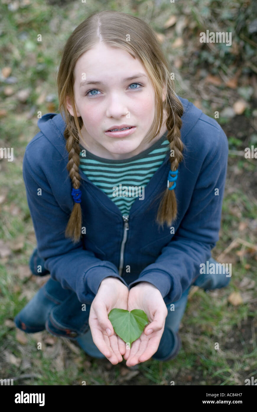 Portrait Of A 13 Year Old Girl With A Leaf In It S Hands Stock Photo portrait-of-a-13-year-old-girl-with-a-leaf-in-it-s-hands-stock-photo