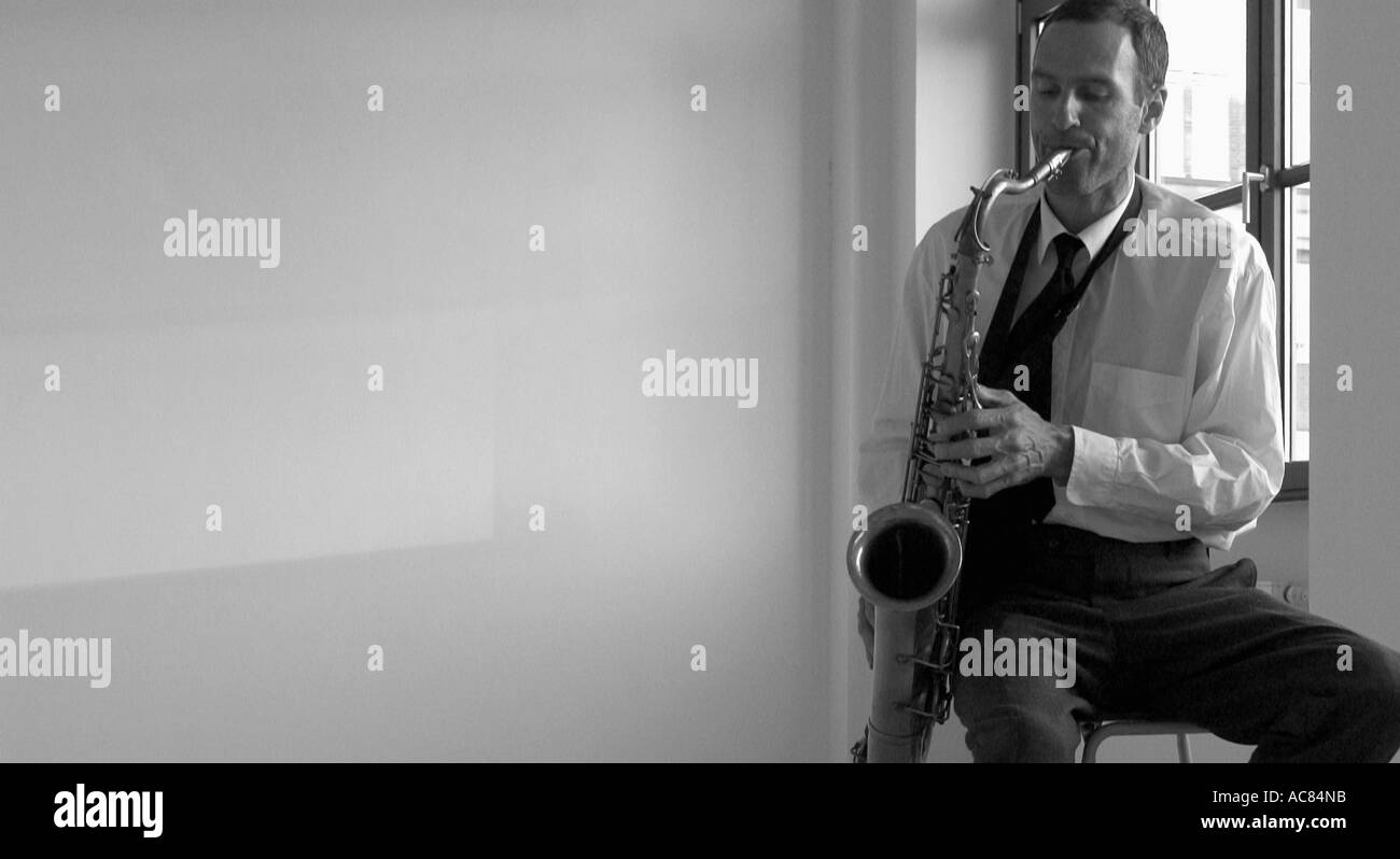 Man mid 30 s playing saxophone Stock Photo