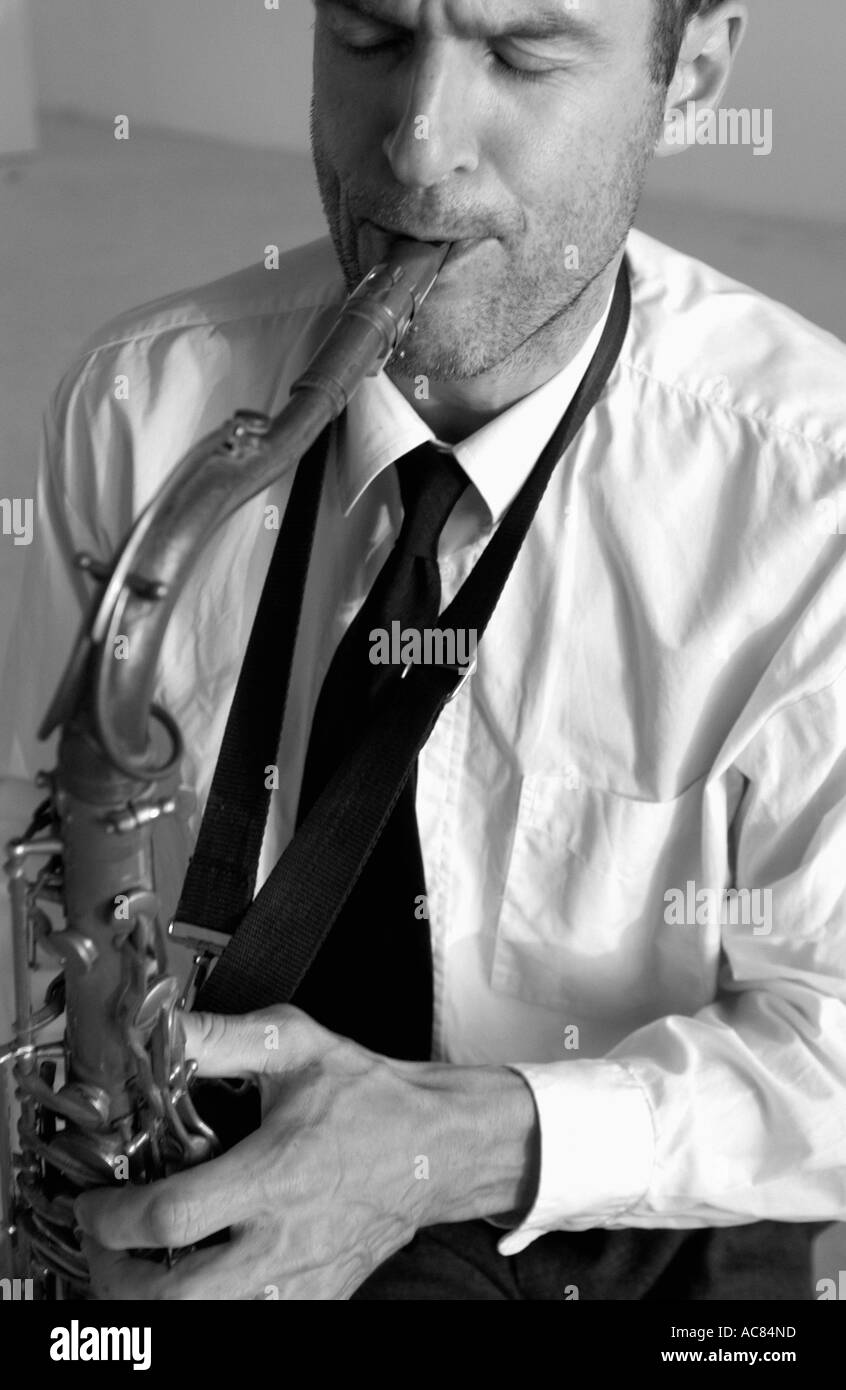 Man mid 30 s playing saxophone Stock Photo