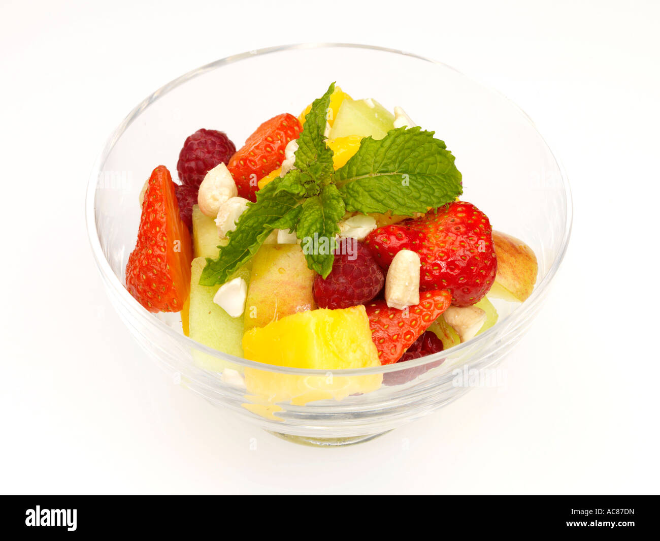 Fresh Healthy Fruit Salad served In A Glass bowl Or Dish Isolated Against A White Background With No People and A Clipping Path Stock Photo