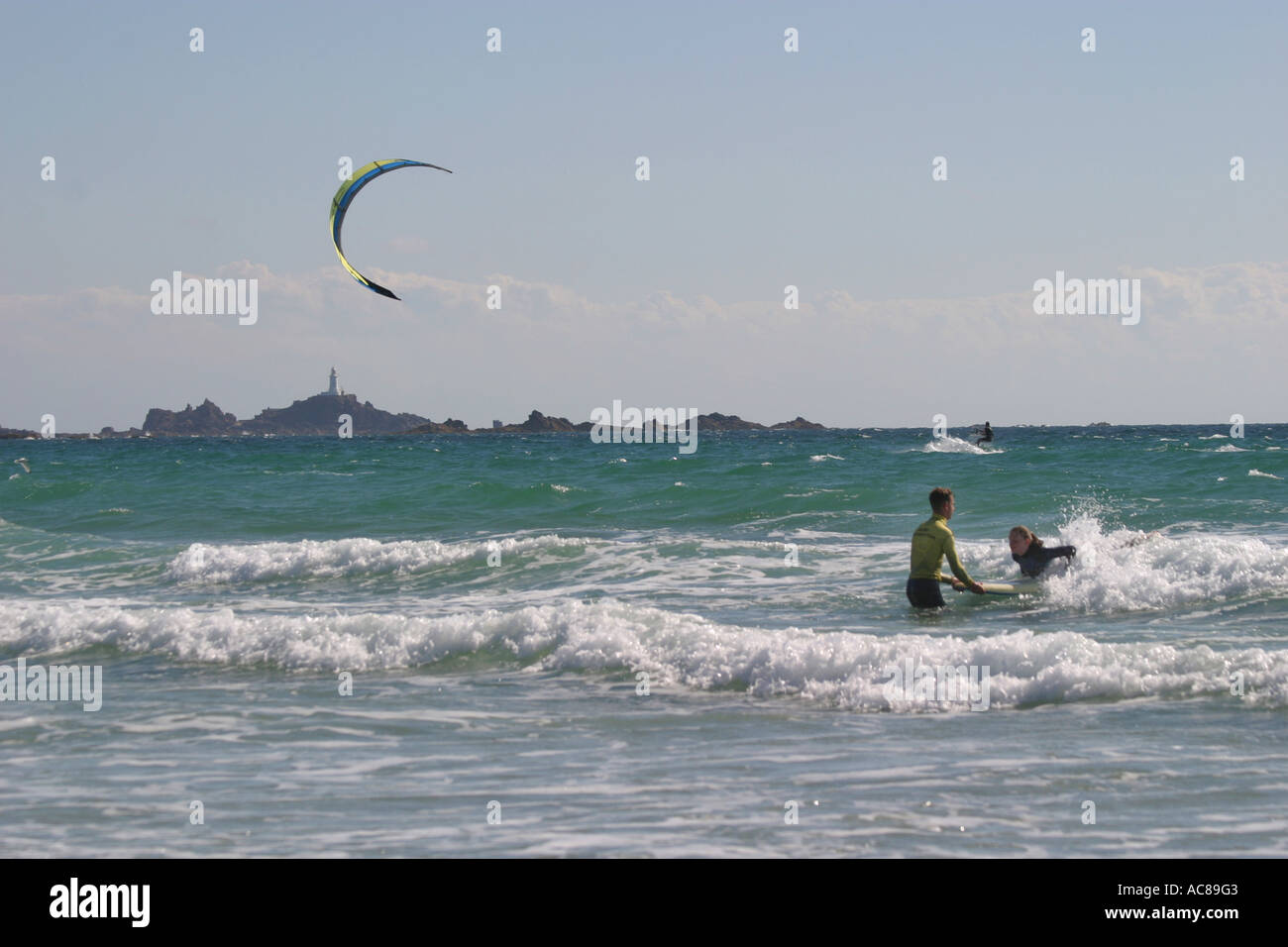 Two young teenage girls first surfing lesson on St Ouen's Beach Jersey