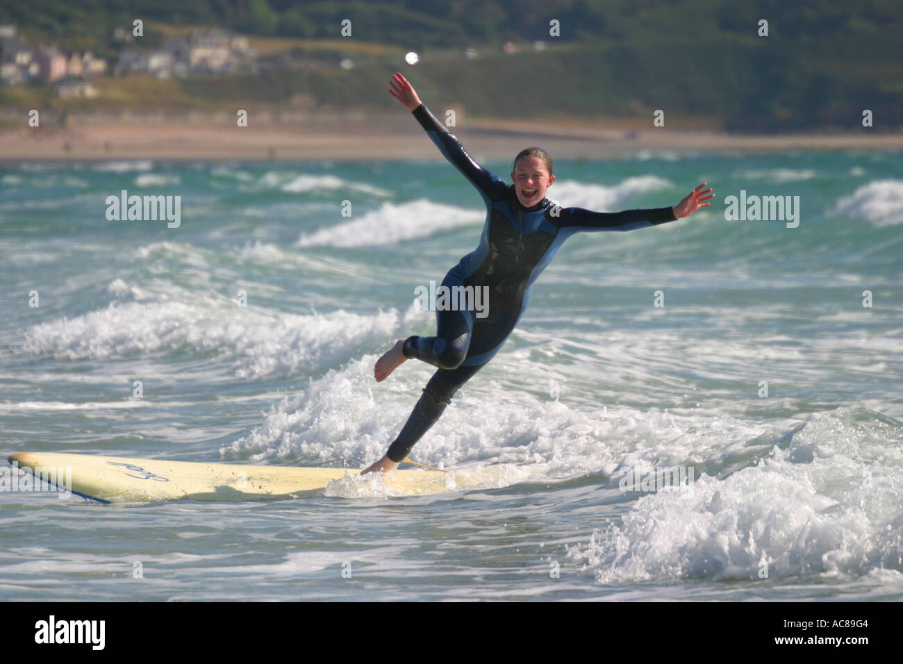Two young teenage girls first surfing lesson on St Ouen's Beach Jersey