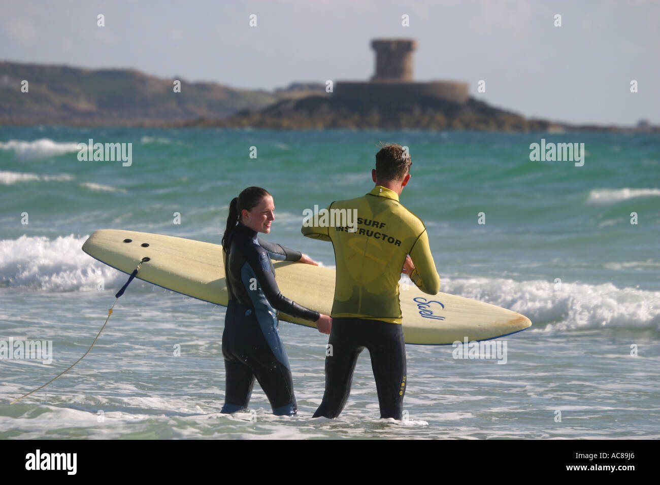 Two young teenage girls first surfing lesson on St Ouen's Beach Jersey