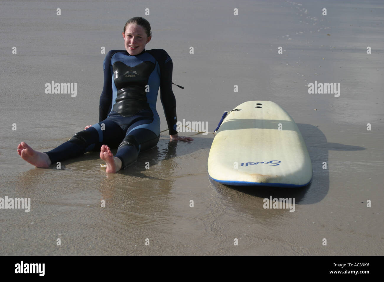 Two young teenage girls first surfing lesson on St Ouen's Beach Jersey